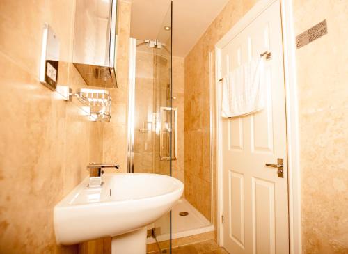 a bathroom with a white sink and a shower at Bridge Hotel Brandon in Brandon