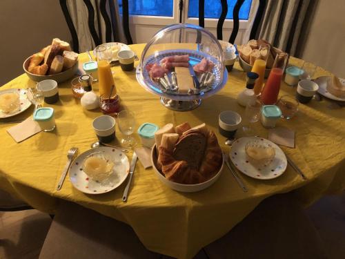 a yellow table with plates of food on it at So Touquet in Le Touquet-Paris-Plage