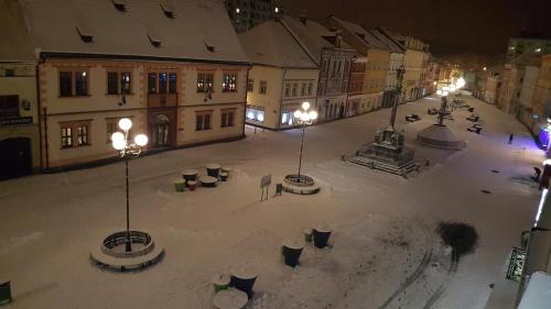 an empty city street at night with lights at Penzion PIANO & Apartment Sokolov in Sokolov