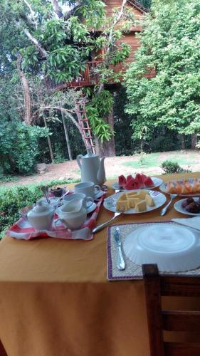 a table with plates of food on top of it at Tree House-Midigama in Weligama