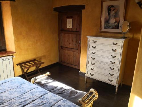 a bedroom with a dresser and a bed and a drawer at Casa rural Can Jepet in La Cellera de Ter