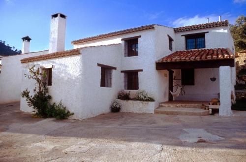 a white house with a chimney on top of it at Casas Rurales Tio Frasquito y Cleto in Yeste