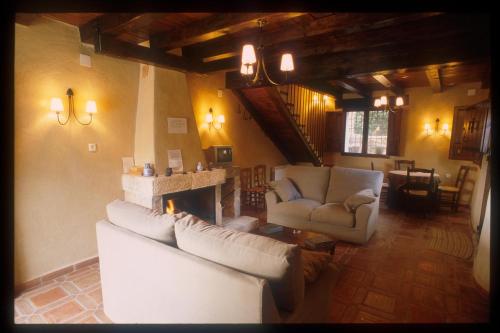 a living room with two couches and a fireplace at Casas Rurales Tio Frasquito y Cleto in Yeste