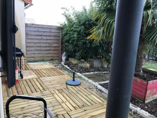 a wooden deck with a cat sitting on it at CosyStudio Site du Futuroscope in Chasseneuil-du-Poitou