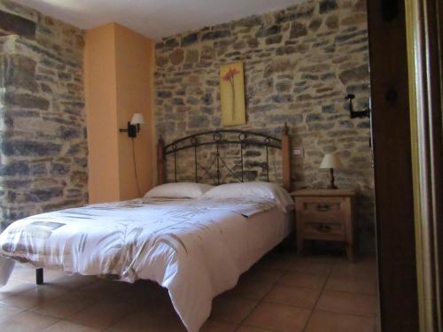 Un pat sau paturi într-o cameră la Hotel rural Valtarranz