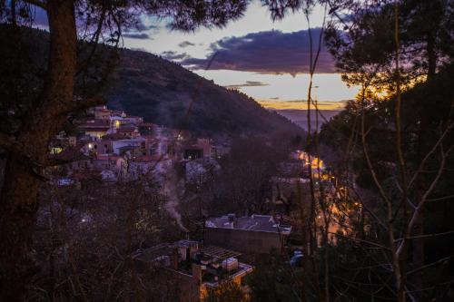 a view of a town on a hill at sunset at Hotel Steni in Stení Dhírfios