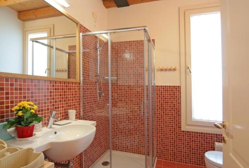 a bathroom with a glass shower and a sink at Locanda Al Ponte de Fero in Jesolo