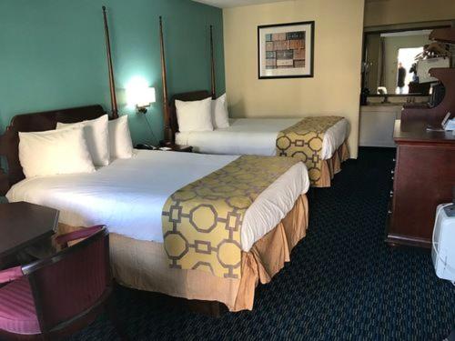 a hotel room with two beds in a room at Baymont Inn & Suites by Wyndham Florence in Florence