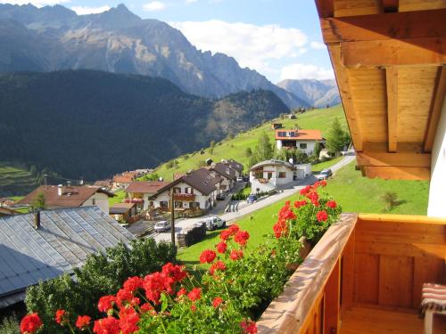 a view from a balcony of a village with flowers at Haus Brigitte in Nauders