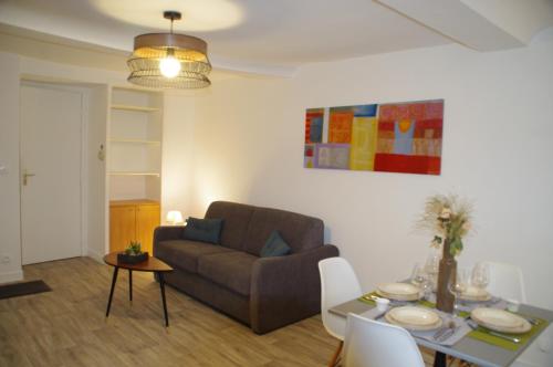 a living room with a couch and a table at La Cour Royale in Bayeux
