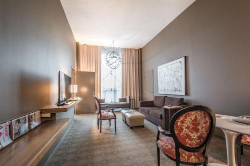 a living room with a couch and a table at Proximity Hotel in Greensboro