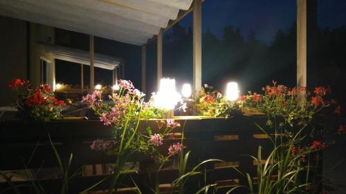 a room with flowers and candles in the dark at Pokoje Gościnne Przylesie in Łobez