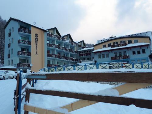 a row of buildings in the snow next to a bridge at Apartmán Šafran in Donovaly