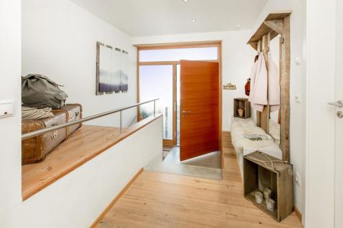 a room with a hallway with a bed and a staircase at Louisa in Oberstdorf