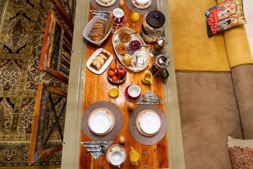 a table with plates and bowls of food on it at Bayiri Petit Pension in Litochoro