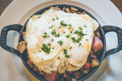 a bowl of food with an egg on top at Proximity Hotel in Greensboro