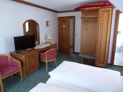 1 dormitorio con escritorio, ordenador y cama en Decker's Bio Hotel zum Lamm, en Baiersbronn