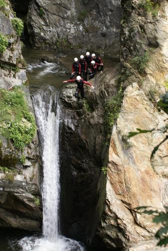 a group of people standing on the side of a waterfall at Ötztal Chalet in Sautens