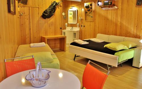 a room with a bed and a table with chairs at Villa Ana Margarida by Nature in Ericeira