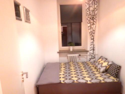 ワルシャワにあるCentral Warsaw Apartmentの窓付きの客室の小さなベッド1台分です。