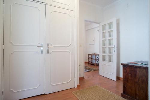 a room with two white doors and a hallway at Apartamento da Estação in Monção