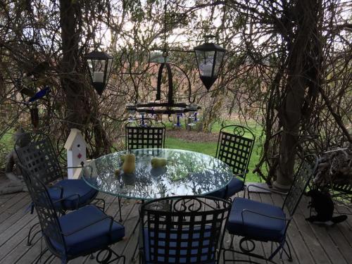 a glass table and chairs on a patio at Lulu's Bed & Breakfast in Niagara-on-the-Lake