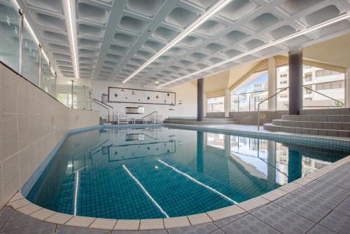 a large swimming pool in a building at Surfers Aquarius on the Beach in Gold Coast
