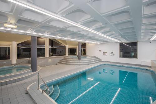 a large swimming pool in a building with a swimming pool at Surfers Aquarius on the Beach in Gold Coast