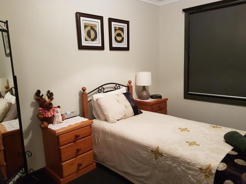 a bedroom with a bed and a dresser and a mirror at Wudinna Farm View in Wudinna