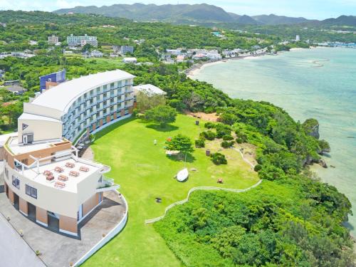 an aerial view of a hotel and the ocean at Marine Piazza Okinawa in Motobu