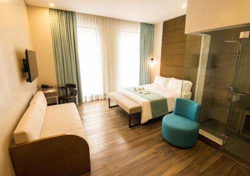 Postel nebo postele na pokoji v ubytování Goldberry Lite Hotel
