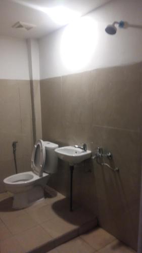 a bathroom with a toilet and a sink at Anyar in Mataram