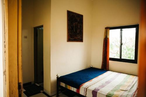 A bed or beds in a room at La Javanaise Home Stay Malioboro