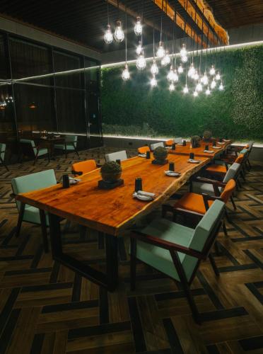 a long wooden table with chairs in a room at Radisson Blu Hotel, Abu Dhabi Yas Island in Abu Dhabi