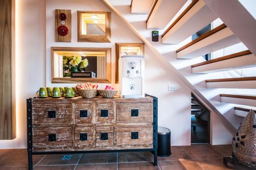 a room with a wooden cabinet with a refrigerator on top at Dreamer Boutique Hotel in Nanwan