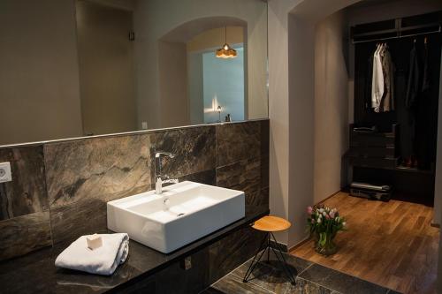 a bathroom with a white sink and a mirror at Emmerich Hotel Görlitz in Görlitz