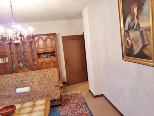 a living room with a couch and a painting on the wall at 3 Sterne Ferienwohnungen Wachter in Bischofsgrün