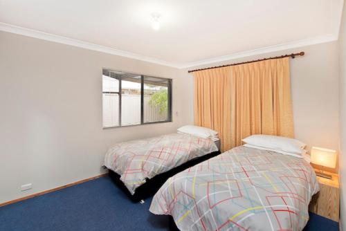 a hotel room with two beds and a window at Abbey Beach Shack in Busselton