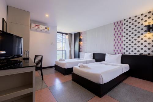 Postel nebo postele na pokoji v ubytování Pen Ta Hug Hotel