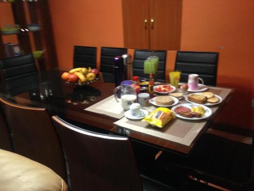 a table with food and a bowl of fruit at Chester View Homestay in Syokimau