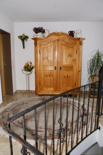 a staircase with a wooden cabinet in a room at Haus Sorgschrofen in Pfronten