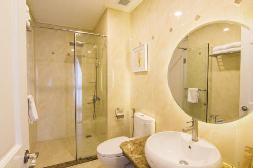 a bathroom with a shower and a sink and a toilet at Phoenix Hotel Vung Tau in Vung Tau