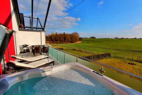 a hot tub with a view of a field at Villa Grande Fewo Relax We 4 in Göhren-Lebbin