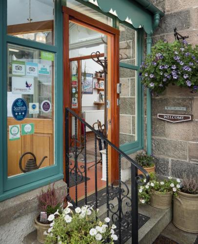 an entrance to a store with a glass door at Cairngorm Guest House in Aviemore