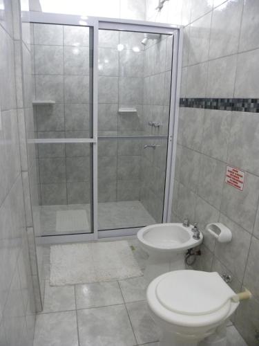 a bathroom with a shower and a toilet and a sink at Iguassu Flower Garden in Puerto Iguazú