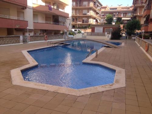 a large swimming pool in the middle of a building at VicAm Atico Duplex in Pineda de Mar