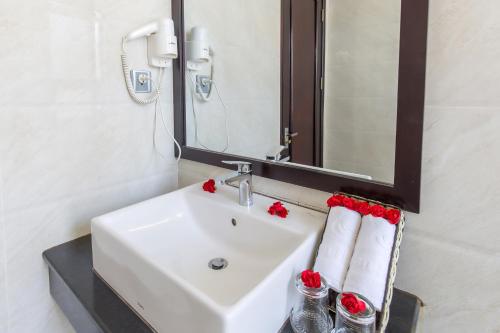 a bathroom with a sink and a mirror at Ocean Haven Hotel in Da Nang