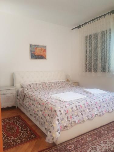 a bedroom with a bed and a window at Villa Maja in Omišalj