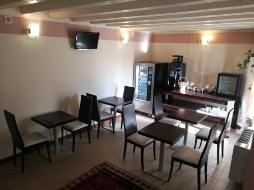 a restaurant with tables and chairs in a room at Sweet Home in Treviso