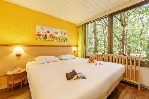Ένα ή περισσότερα κρεβάτια σε δωμάτιο στο Center Parcs Les Hauts de Bruyères